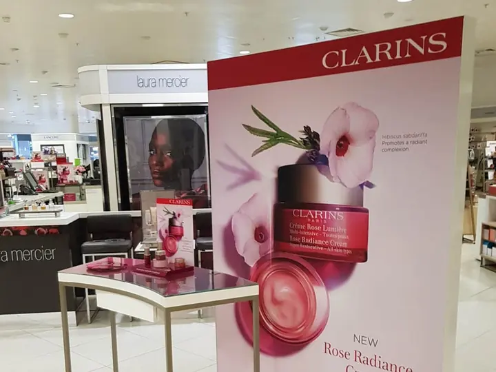 Clarins counter graphics installed in a beauty hall