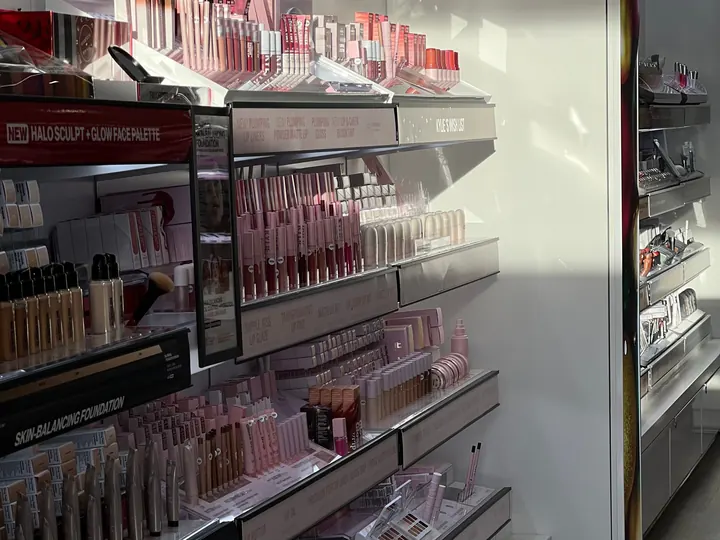 Beauty aisle with merchandised cosmetics displays in a health and beauty store