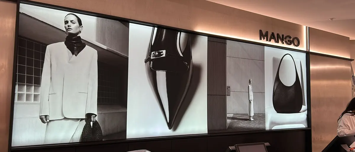 Illuminated Mango lightbox graphics installed along a fashion store wall